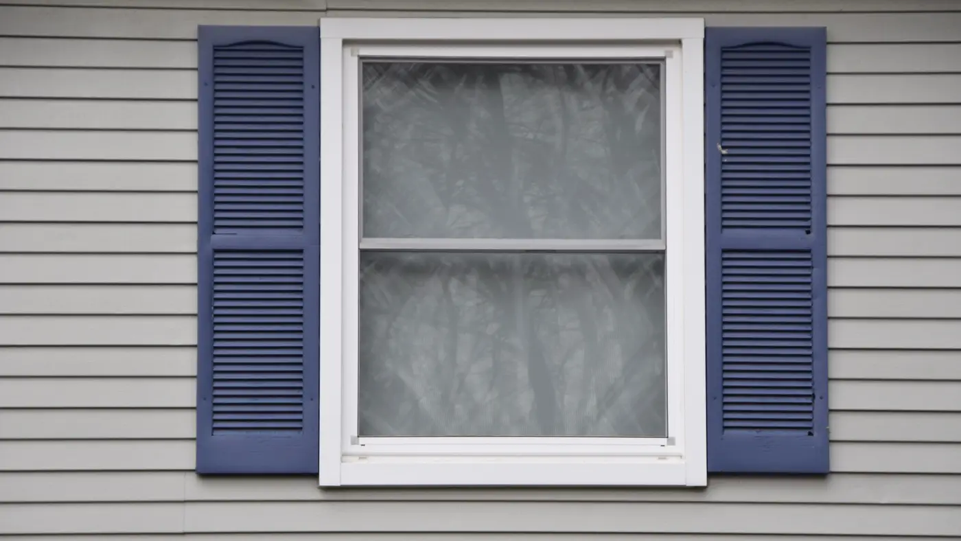 Double Hung Windows By Rockman Windows And Doors In Sag Harbor, NY White double-hung windows with gray siding and white trim