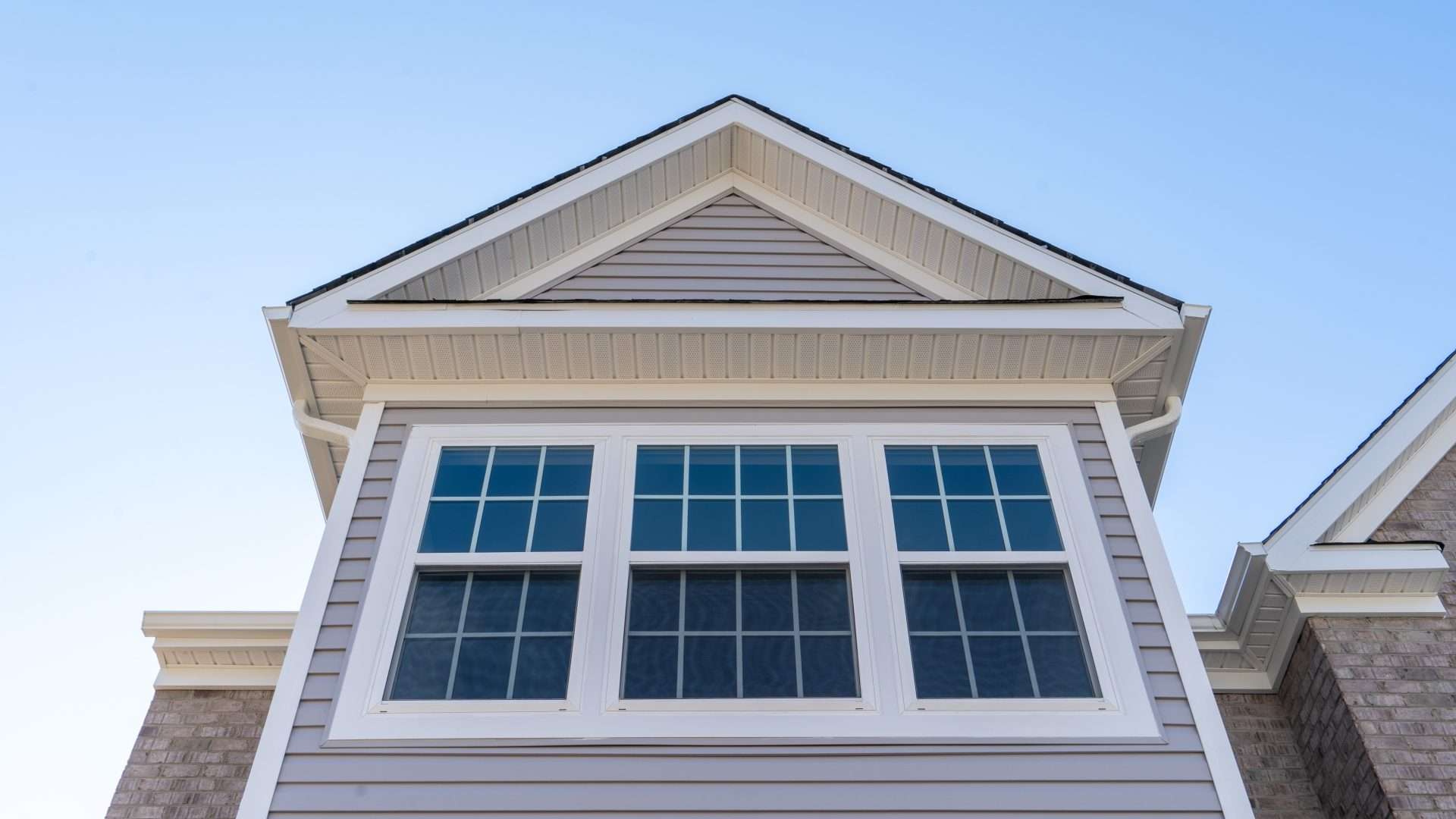 Home with white siding with three double-hung windows in Bridgehampton, NY