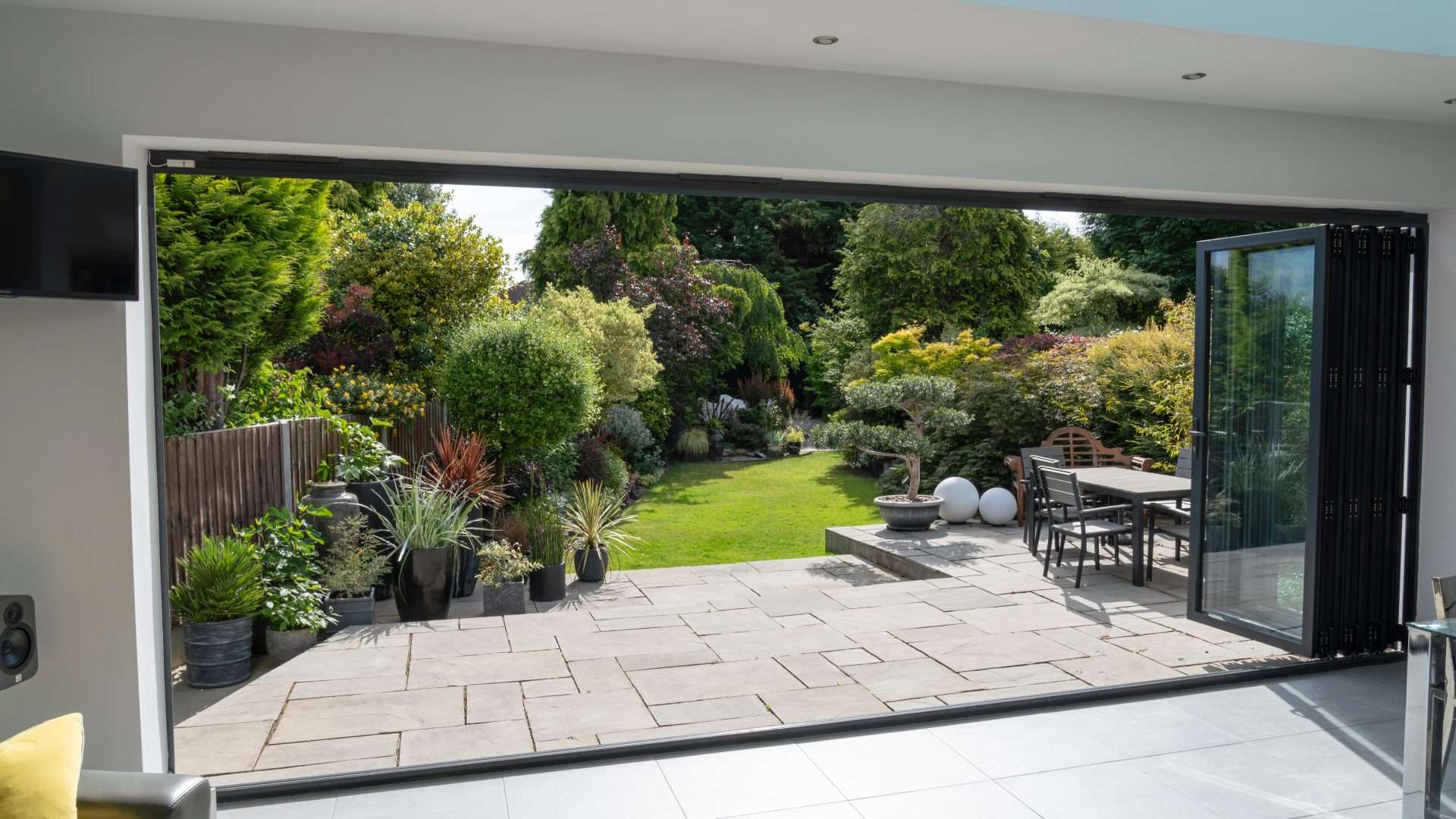 Interior view through a wide-open, multi-panel folding patio door