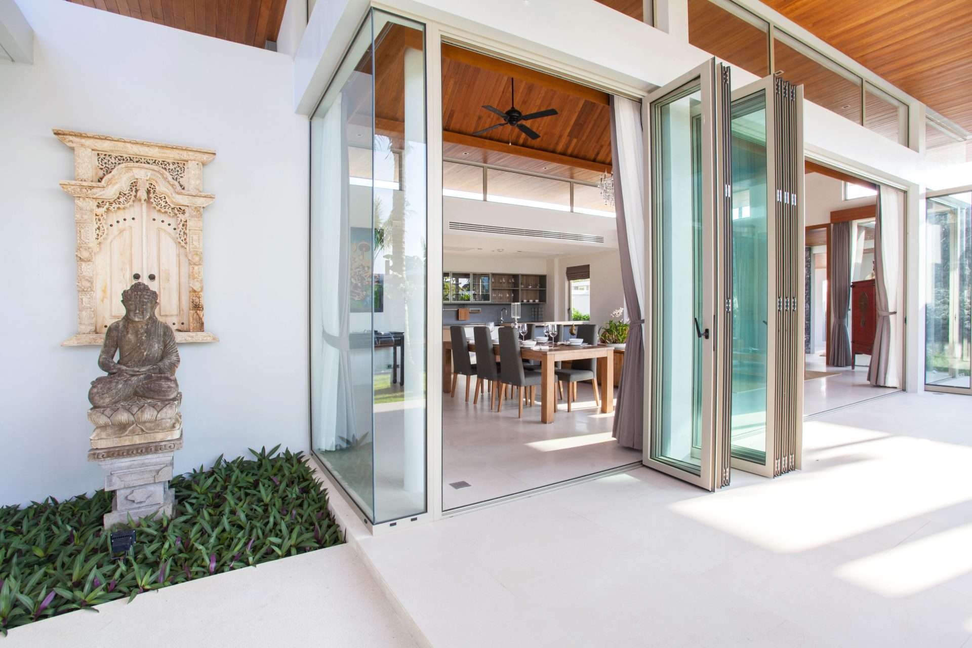 Contemporary folding glass doors from patio to dining room