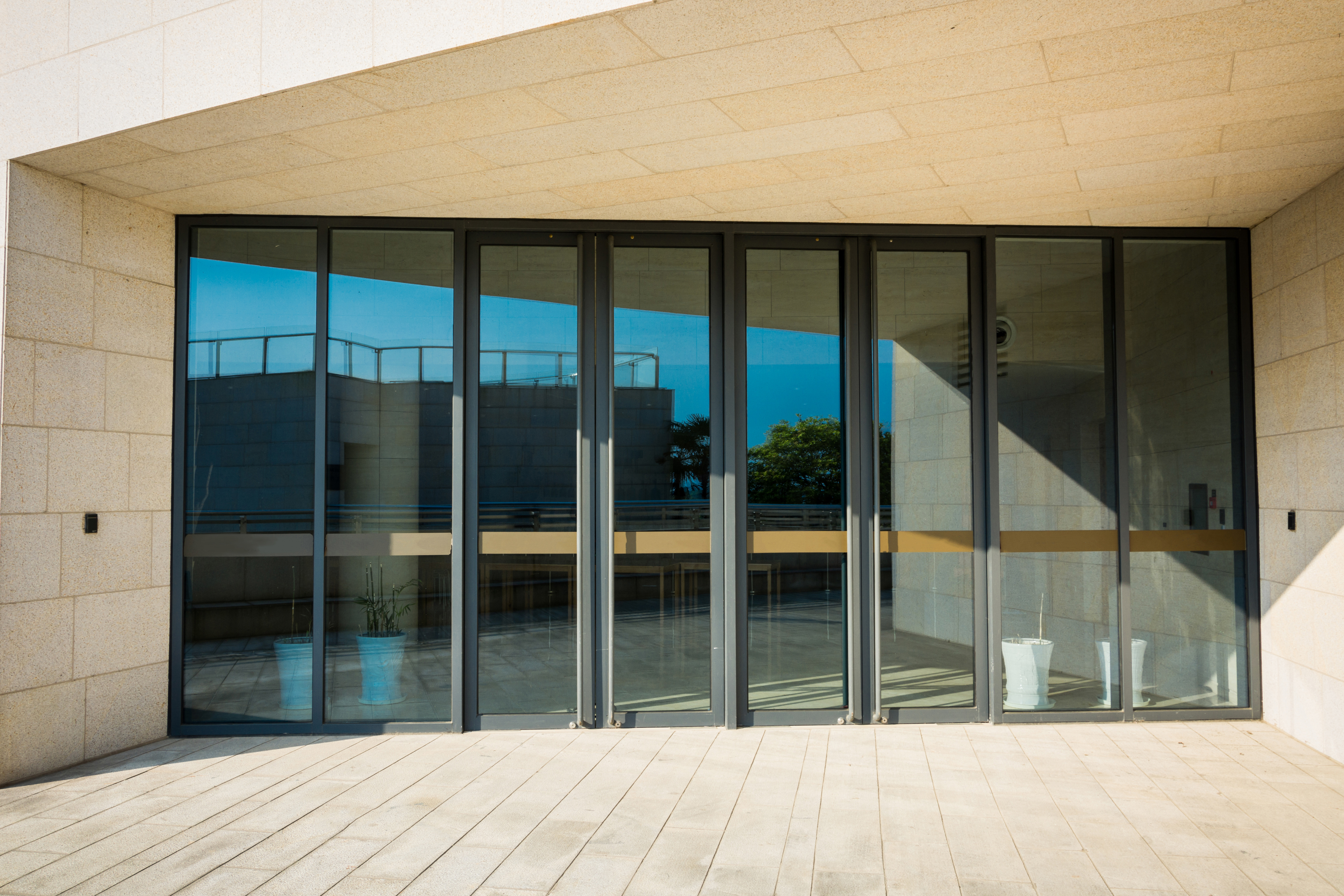 Exceptional Doors in Greenwich, CT | Rockman Windows & Doors Bifold doors against a stone residence.