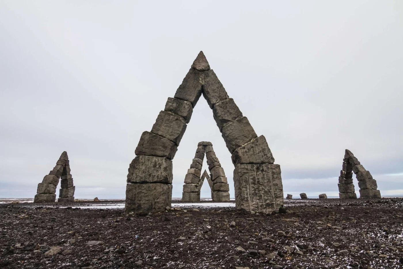 Ancient sundial under a cloudy sky in Iceland.