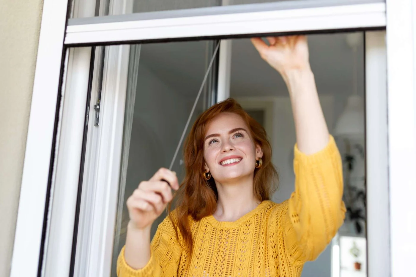 Expert Double Hung Windows In Cold Spring, NY A homeowner enjoying double-hung windows on a pretty day.