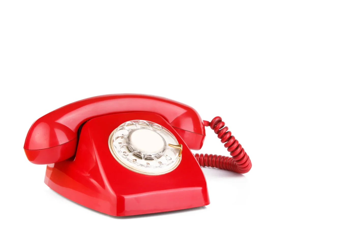 A bright red rotary phone against a white background.